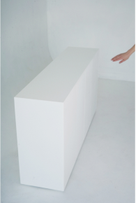 Front view of sideboard of monolith geometry with four doors against white background.
